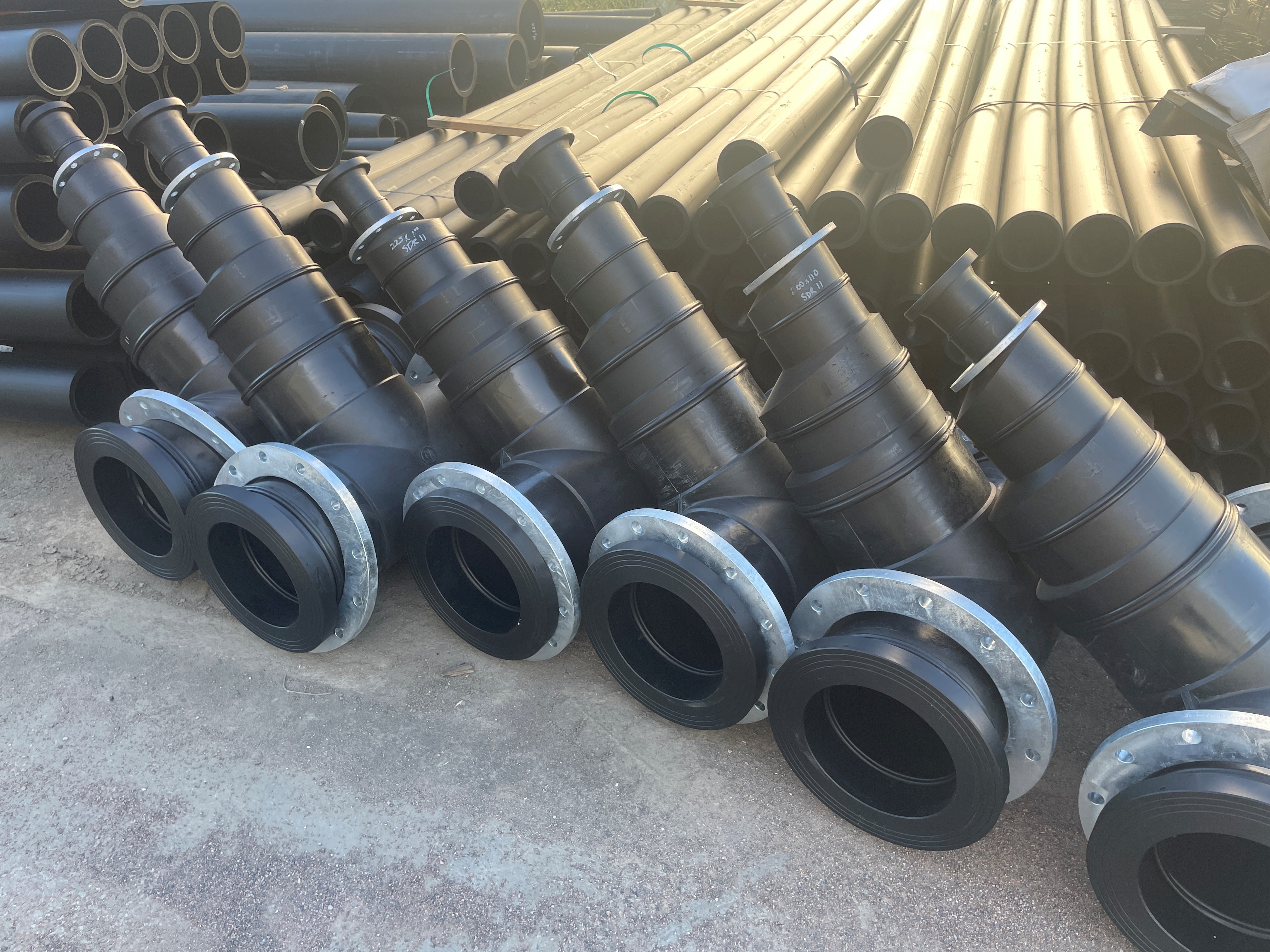 An image of flanged scour tees with eccentric reducers welded to them.
