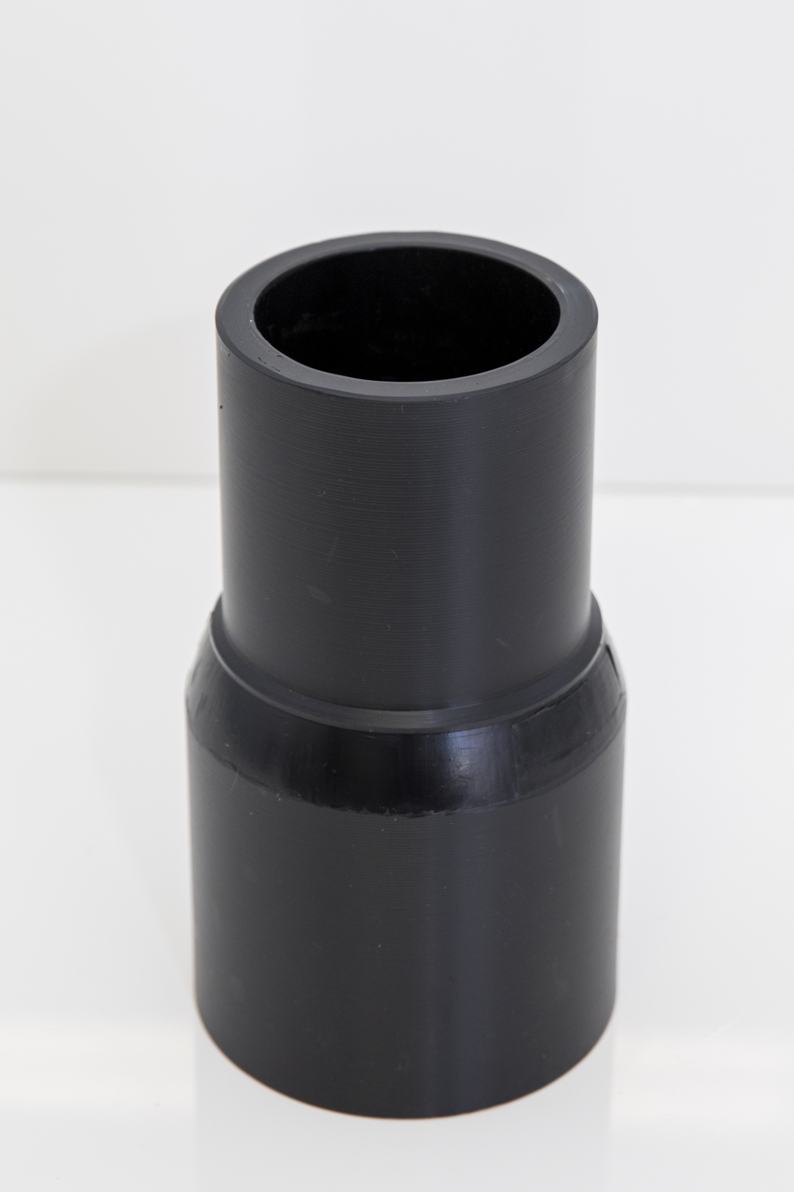 An image of a long spigot polyethylene concentric reducer against a white background.